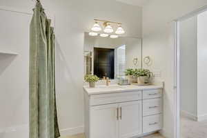 Full bath with vanity and curtained shower