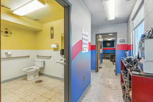 Bathroom with baseboards and light flooring
