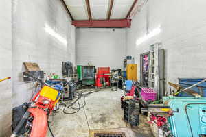 Garage featuring concrete block wall