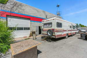 View of front facade featuring roof with shingles and concrete block siding