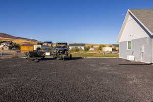 View of side yard designed as extra parking for RV, boat, ATV, etc.