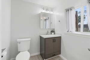 Bathroom featuring vanity and wood finish floors