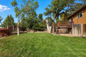 View of yard with stairway and a deck