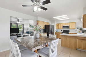 Dining area featuring light tile patterned flooring and ceiling fan