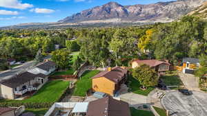 Aerial view of property's location with nearby suburban area and a mountain backdrop