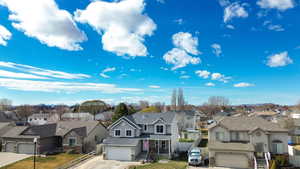 View of front of house featuring a residential view, stone siding, stucco siding, and a garage