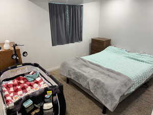 Carpeted bedroom with baseboards