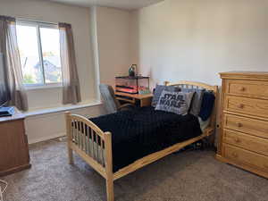 Carpeted bedroom featuring baseboards