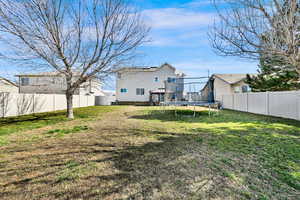 Rear view of property with a fenced backyard