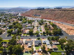 Aerial overview of property's location featuring a mountainous background and nearby suburban area