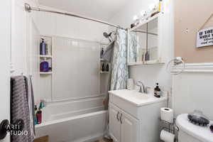 Full bathroom featuring shower / bath combination with curtain, vanity, and crown molding