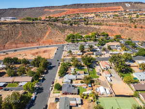 Aerial view of property and surrounding area with nearby suburban area and mountains