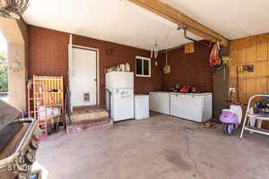 Garage with freestanding refrigerator and white fridge