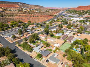 Aerial view of property's location with mountains and nearby suburban area