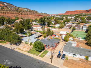 Aerial overview of property's location featuring a mountain backdrop and nearby suburban area