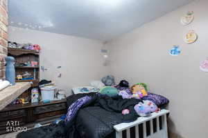 Bedroom featuring a textured ceiling
