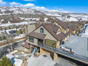 Snowy aerial view with a mountain view and a residential view