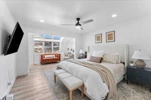 Bedroom with light wood-style flooring, ceiling fan, and recessed lighting