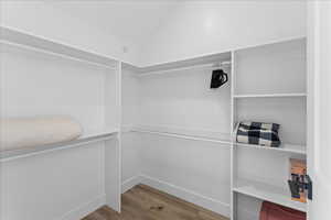 Spacious closet with light wood finished floors