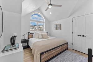 Bedroom featuring light wood-type flooring, a ceiling fan, a closet, recessed lighting, and high vaulted ceiling