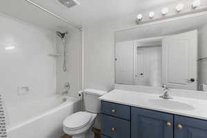 Bathroom with shower / tub combo with curtain and vanity