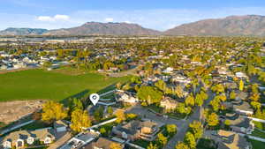 Aerial view of property's location featuring nearby suburban area and mountains