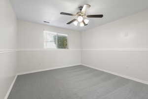 Unfurnished room featuring carpet and ceiling fan