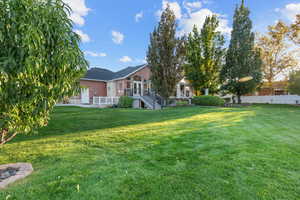 View of yard with a patio and a deck