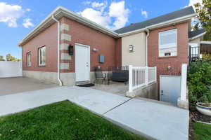 Rear view of property featuring a patio area and brick siding
