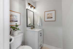 Half bathroom featuring vanity and toilet