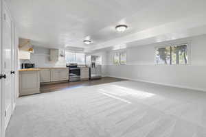 Kitchen featuring light countertops, stainless steel appliances, healthy amount of natural light