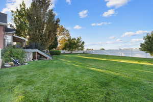 Fenced backyard with stairway and a deck