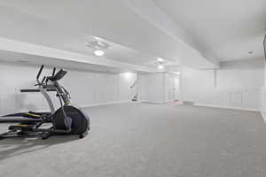 Workout area with light colored carpet