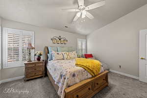 Bedroom with lofted ceiling, carpet, and ceiling fan