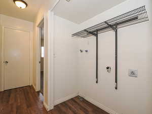 Laundry room featuring dark wood-style floors and hookup for a washing machine
