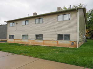 View of side of home with a lawn