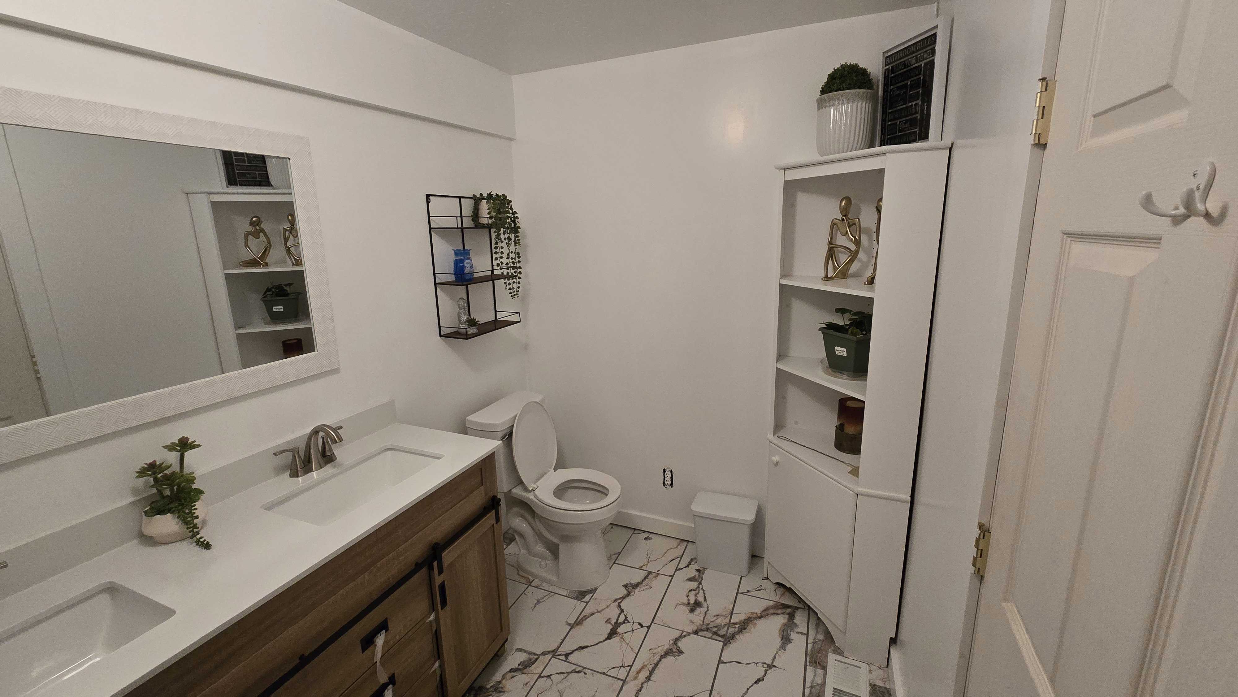 Double vanity with undermount sinks and wood-finish cabinetry
