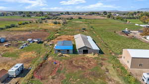 Overview of rural landscape featuring abundant farmland and a mountainous background