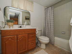 Full bathroom with vanity, shower / bath combo