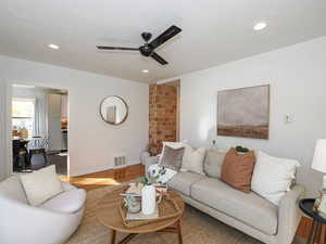 Living area with view to kitchen and charming exposed brick