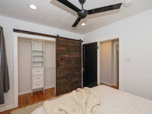 Bedroom featuring a barn door for closet
