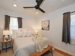 Bedroom (1) featuring ceiling fan, recessed lighting, & wood floors