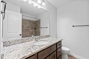 Full bathroom featuring vanity, tiled shower, and light tile patterned flooring