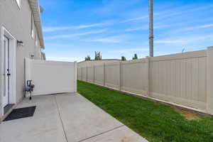 Fenced backyard with a patio area