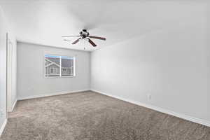 Unfurnished room featuring light carpet, a textured ceiling, and a ceiling fan