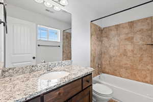 Bathroom featuring shower / washtub combination and vanity