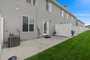 Rear view of house with a patio area and stucco siding