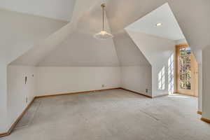 Bonus room featuring recessed lighting, light colored carpet, and lofted ceiling