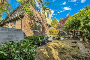 View of side of home featuring a fenced backyard and brick siding