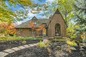 Tudor-style house with brick siding and a chimney